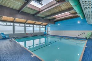 a large swimming pool in a large room at Oceanfront Studio - Ground Floor - King Bed - Easy Beach Access - Pool & Hot Tub in Lincoln City