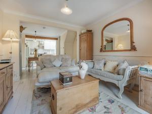 a living room with a couch and a table at Greenfield Cottage 1866 in Broadwater