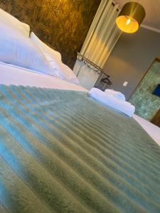 a bedroom with a large bed with blue sheets at Amoras suítes in Sao Jorge