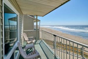 a porch with two chairs and the beach at Corner Oceanview King Suite Full Kitchen Beach Access Pool & Hot Tub in Lincoln City