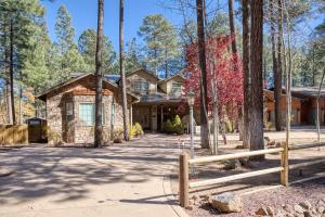 a house with a fence in front of it at Embrace the Fore Seasons in Pinetop! in Indian Pine
