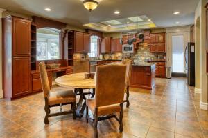 a large kitchen with a wooden table and chairs at Embrace the Fore Seasons in Pinetop! in Indian Pine