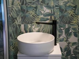 a white sink on a counter in a bathroom at WoodEscape house in Petrovaradin +8 photos