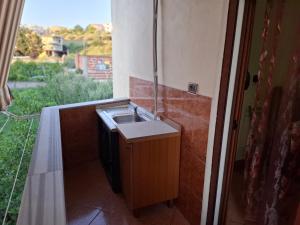 a bathroom with a sink and a window at Vila Rrodhe in Durrës
