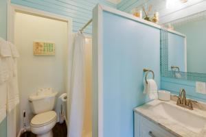 a bathroom with a toilet and a sink and a mirror at Peaceful Gouldsboro Vacation Rental with Grill in Gouldsboro +16 photos