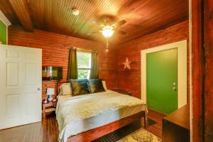 a bedroom with a bed and a green door at Peaceful Gouldsboro Vacation Rental with Grill in Gouldsboro