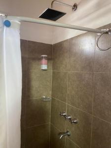 a bathroom with a shower with a shower head at Monoambiente en posadas in Posadas +9 photos