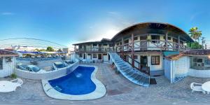 a resort with a slide in front of a building at Pousada Mar de Porto in Porto Seguro