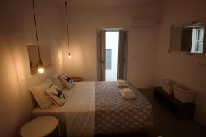 a bedroom with a bed with two towels on it at Summer Addicts Home, for the young at heart! in Naousa