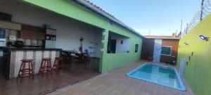 a patio with a swimming pool in a house at Casa com dois quartos e piscina in Barreirinhas