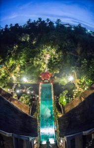 an aerial view of a pool at a resort at night at Avalon Ubud Castle & SPA in Ubud
