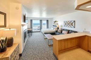 a living room with a couch and a living room with at Oceanfront Suite - King Bed - Heated Indoor Pool & Hot Tub in Lincoln City