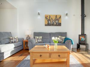 a living room with a couch and a coffee table at Wonkey Donkey Cottage in Seaton