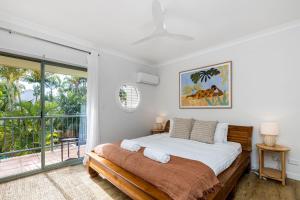 a bedroom with a large bed and a balcony at Byron Beachside 5 in Byron Bay +40 photos