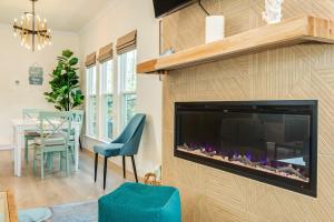 a living room with a large fireplace and a blue chair at Hidden Paradise in Galveston