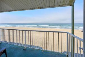 a balcony with a view of the beach at Oceanfront Family Suite - Full Kitchen - Beach Access - Pool & Hot Tub in Lincoln City