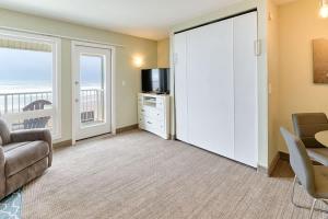 a living room with a couch and a television at Stunning Oceanfront Suite - Full Kitchen - Pool and Hot Tub in Lincoln City