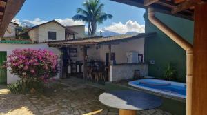 a house with a patio and a swimming pool at Casa Soul Green in Paraty