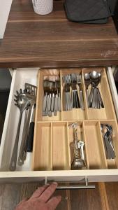 a drawer filled with lots of utensils on a counter at 80 m2 Rooftop Apartment with Balcony & Free Parking in Gerasdorf bei Wien +16 photos