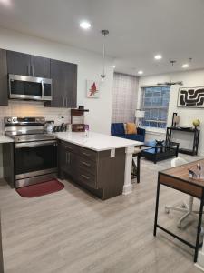 an open kitchen and living room with a couch at FellPoint Harbor Hideaway Haven in Baltimore