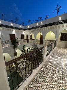 a courtyard of a house with a balcony at Riad Dar Melia in Marrakesh