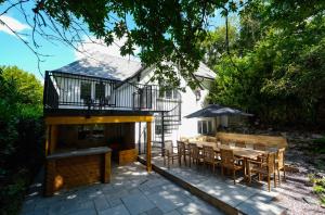 a house with a patio with a table and chairs at North Cottage - A Stylish Family Retreat Once Owned by Beatrix Potter in Bowness-on-Windermere