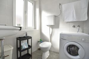 a bathroom with a washing machine and a sink at Stone & Sea in Budva +17 photos