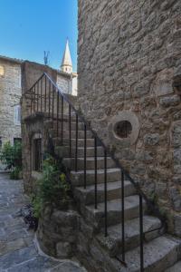 a set of stairs in a stone wall with a stair case at Stone & Sea in Budva