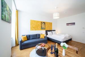 a living room with a couch and a bed at Premium Cosy Apartment with Free Parking in Vienna