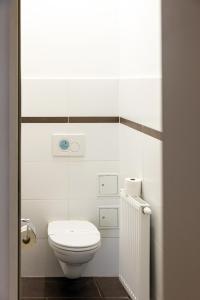 a white bathroom with a toilet and a window at Premium Cosy Apartment with Free Parking in Vienna