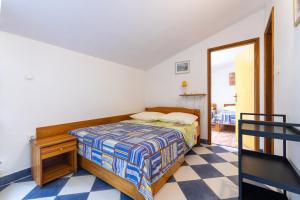 a bedroom with a bed and a mirror at Apartments by the sea Sucuraj, Hvar - 3589 in Sućuraj