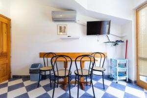 a room with a table with chairs and a flat screen tv at Apartments by the sea Sucuraj, Hvar - 3589 in Sućuraj