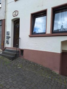 a building with two windows and a staircase outside at Apartment B&J Cochem in Cochem