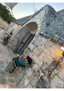 a bowl of fruit sitting on top of a building at Trullincanto Monopoli by JD Collection in Monopoli