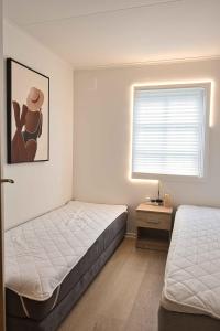 a bedroom with two beds and a window at Family Friendly Home Close To Beach & Gilleleje in Gilleleje
