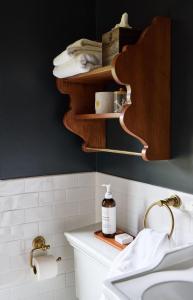 a bathroom with a wooden shelf above a sink at Six Bells Countryside Inn in Rosendale +51 photos