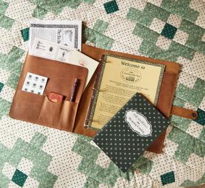a brown wallet sitting on top of a quilt at Six Bells Countryside Inn in Rosendale