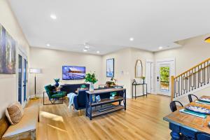 a living room with a couch and a table at White & Black House 8br River in New Braunfels