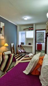 a bedroom with two beds and a living room at Posada El Prado in Salta
