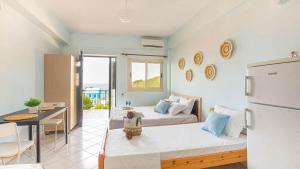 a room with two beds and a refrigerator at Simon Ionian Balcony 1 - Kitchen, Sea View in Himare