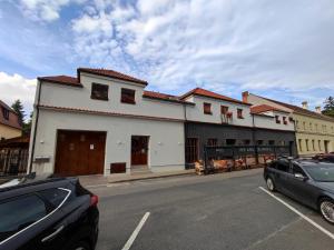 a white building on the side of a street at Penzion U Zamku in Lednice