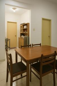 a dining room with a wooden table and chairs at Country heights Homestay in Donggongon