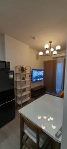 a kitchen with a table and a black refrigerator at The Infinity View in Talisay