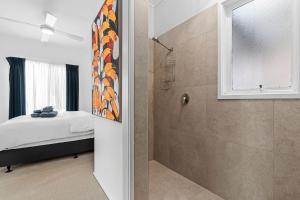 a bedroom with a shower and a bed and a window at Number 9 in Portarlington +4 photos