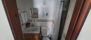 a bathroom with a sink and a toilet and a mirror at Sundown Lodge in Eureka +12 photos