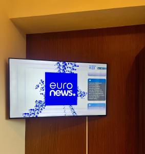 a flat screen tv with a sign on a door at Cebu Minimalism 1 Bedroom in Cebu City +22 photos