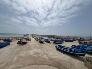 a group of boats parked on the beach at Résidence Al Massira Fnideq in Fnidek +3 photos