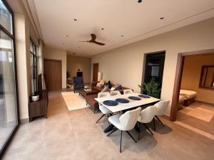 a living room with a table and chairs at JA Accom in Al ‘Ayn