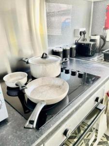 two pots and pans on a stove in a kitchen at Blackpool Pleasure Beach whole Holiday Home! in Blackpool