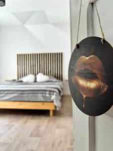 a painting of a mouth hanging in a bedroom at Love room 10 minutes de Nantes in Thouaré-sur-Loire